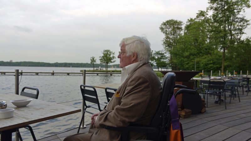 Ruud de Jong in een rolstoel tijdens één van zijn laatste bezoeken aan ‘zijn’ binnenvaartsociëteit De Wandelgang in 2017. (Archieffoto De Wandelgang / Johan Witte)