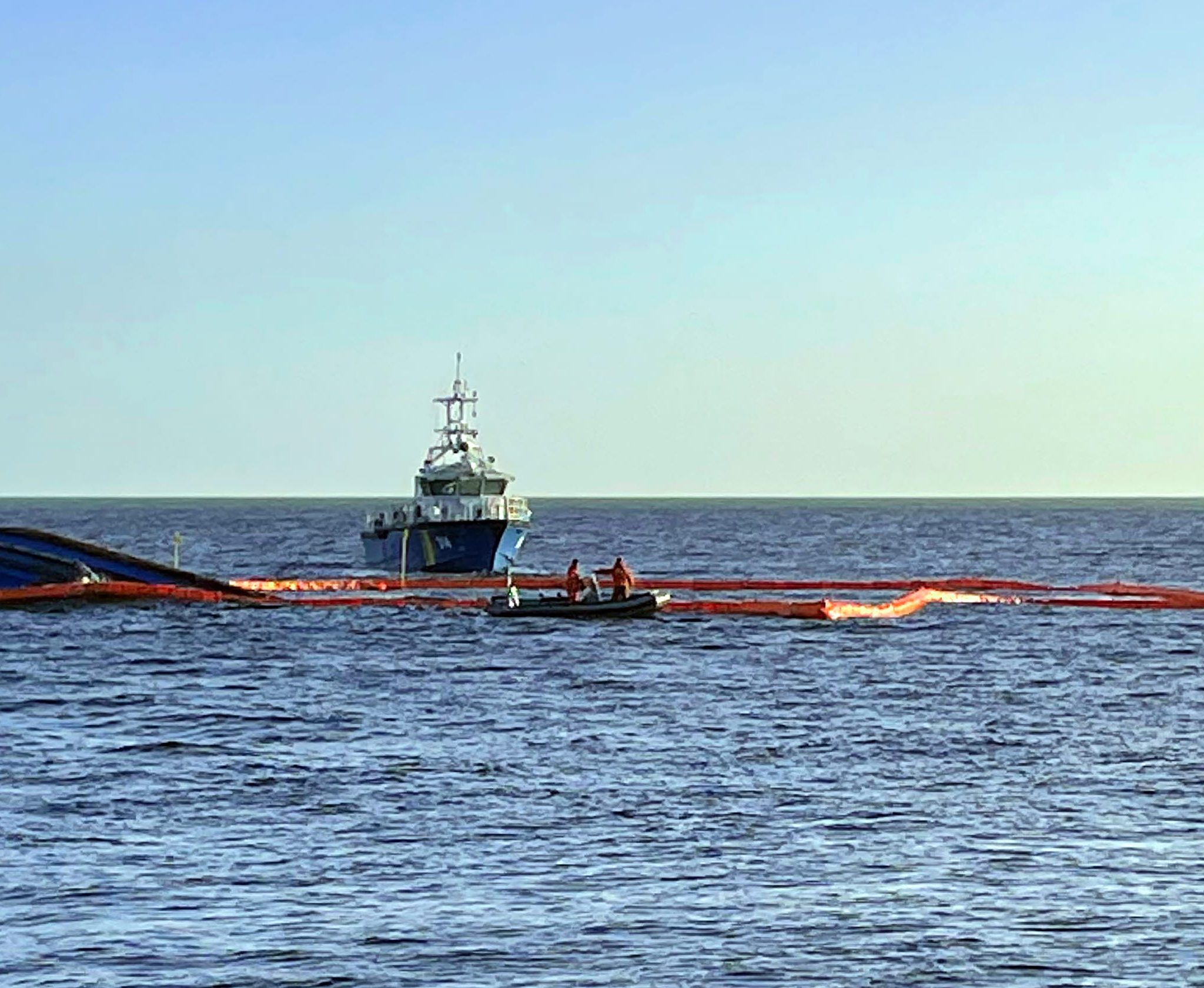 Karin Høj wordt omringd door een olieboom. (Foto Swedish Coast Guard)